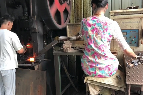 螺纹钢筋通过超音频芭乐污视频加热设备加热后 冲床锻压成螺母坯型